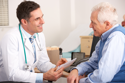 physician talking to an elderly man