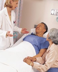 female physician speaking with a patient and his wife
