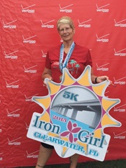 Nancy O. holding an Iron Girl race placard