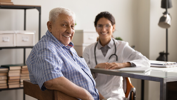 Male sitting with a bariatrics professional