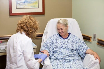 nurse taking blood from a female patient