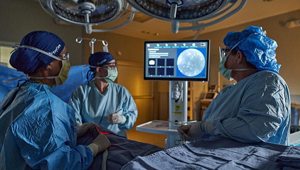 An image depicting surgeons using the Lumicell system to detect breast cancer.