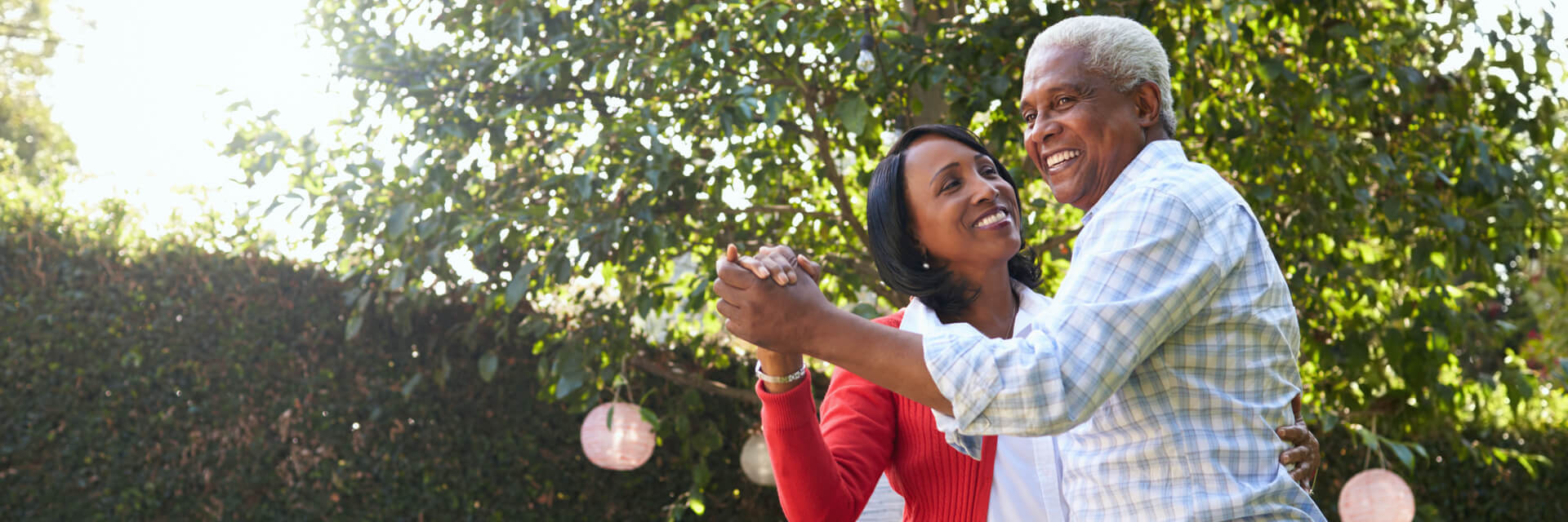 Father dancing in the park with adult daughter