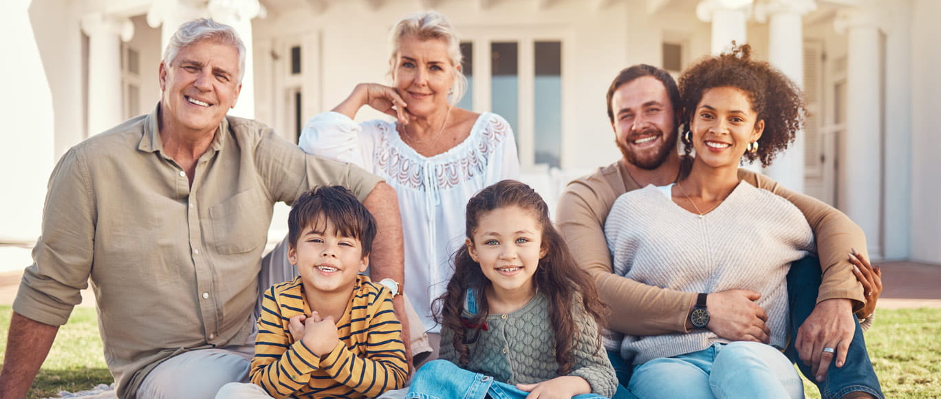 multigenerational family sitting on a floor smiling