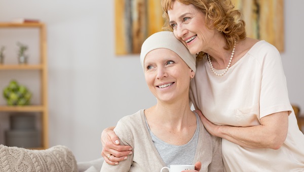 A caregiver offers support to a patient.