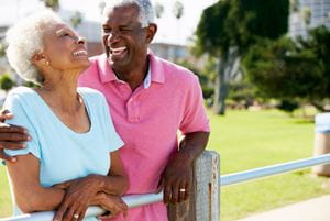 A senior husband and wife are spending time together in a park.