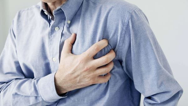 man clutching chest