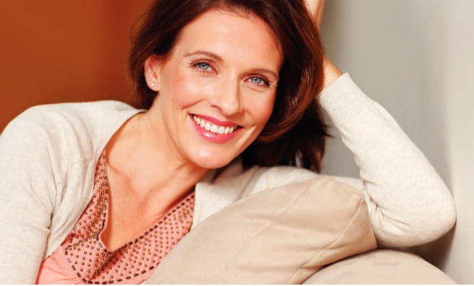 Women with brown hair sitting on a couch