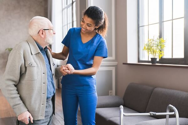 female health professional assisting elderly male