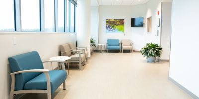 Family waiting room with chairs aligned on the wall in the South Florida Baptist Hospital