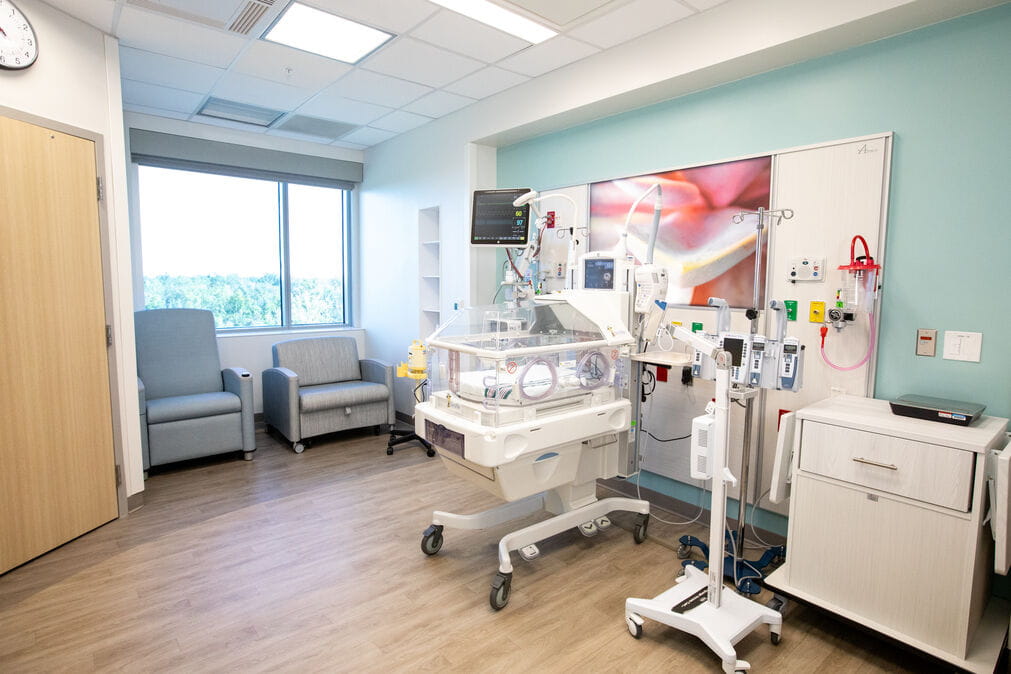 wide angle of a NICU room and 2 lounge chairs