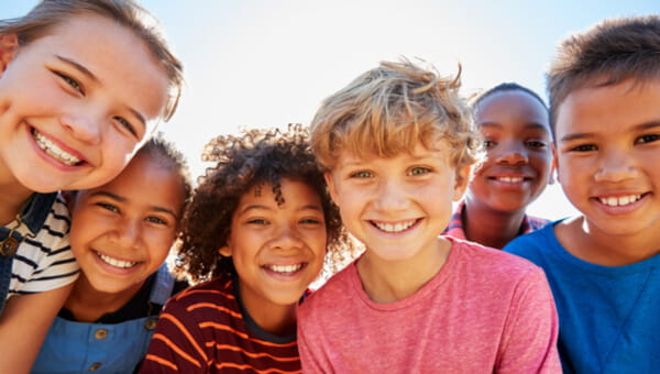 a photo of four kids smiling