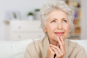 A senior woman is trying to remember something.