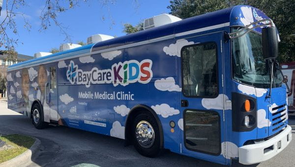 a bus with colorful BayCare kids graphics on it