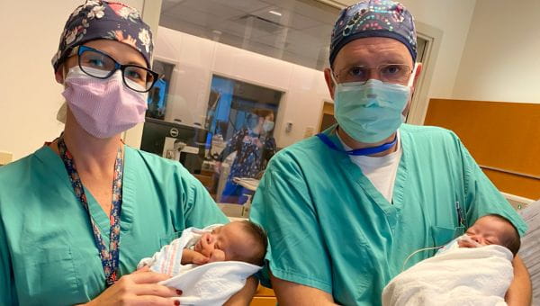 Newborn babies being cared for by healthcare professionals .