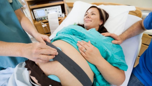 A pregnant woman having pediatric cardiology work done on her baby still in her belly