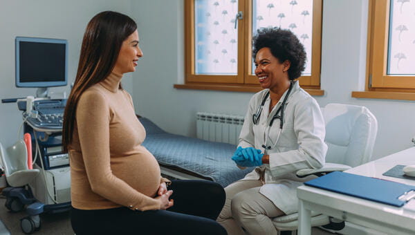 A pregnant woman consulting with a provider