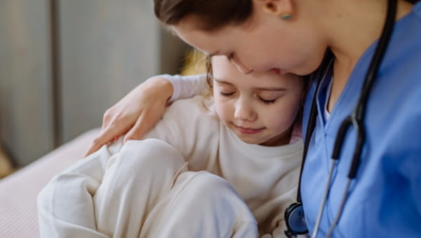 Patient being consoled by a pediatric nurse