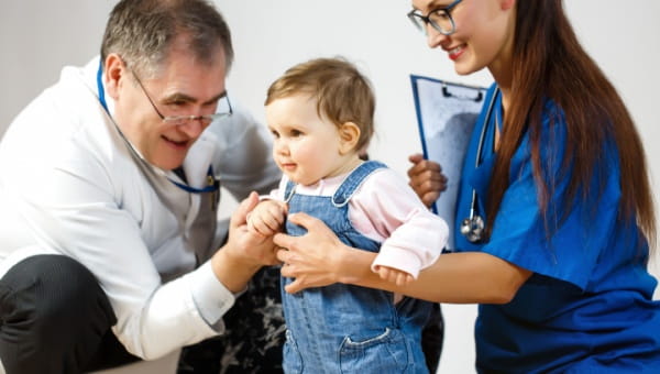 A doctor and a nurse performing a check-up on a pediatric patient