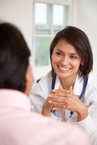 A smiling doctor with a patient have a conversation