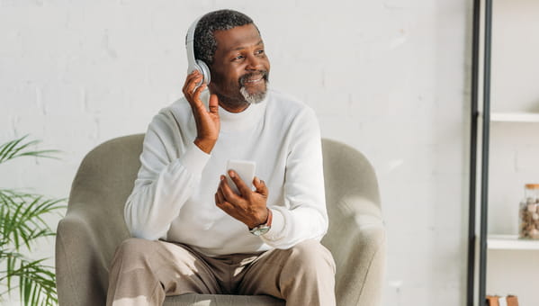 man with headphones sitting in chair