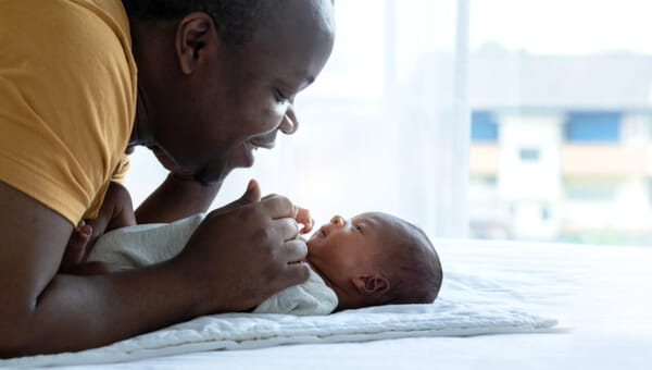 a man comforting a newborn child