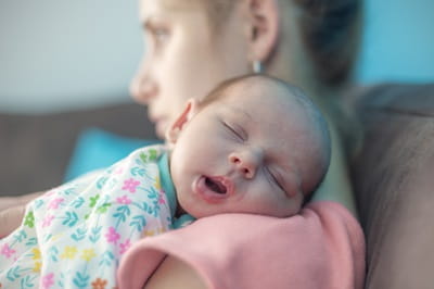 Tired mother suffering from postpartum depression