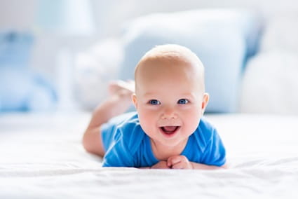 Newborn baby laying on their tummy