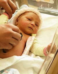 A newborn baby in the hospital nursery